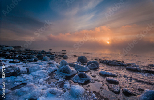 In winter the sun rose slowly over Lake Superior while the open water and -20 F degree air mixed, creating thick wisps of sea smoke. Brighton Beach, Duluth, MN.