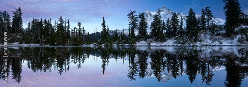 Mount Shuksan is reflected in a lake in late autumn near Mount Baker Ski Area. photo