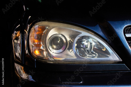 Car headlights. Luxury Headlights. Car details. Part of a blue car