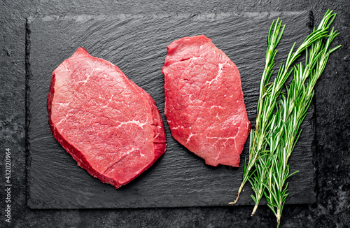 raw beef steak with spices on stone background