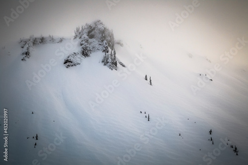 The wind laden slopes below table mountain during a winter storm in the backcountry near Mount Baker. photo