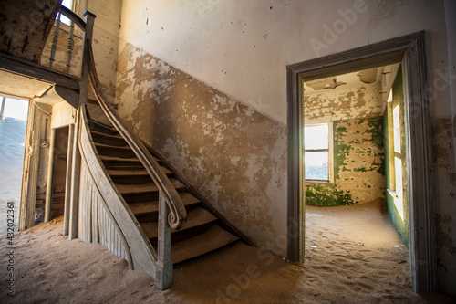 The Kolmanskop settlement where the diamond mine workers lived has been abandoned for over 60 years. Located just outside the city of Luderitz in Namibia. photo