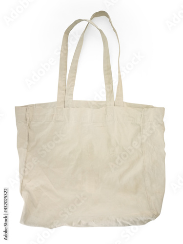 Close up of white canvas tote. Cotton cloth bag isolated on white background. Front view of Blank shopping sack with copy space. Eco bag mockup. Eco friendly, Zero waste concept.