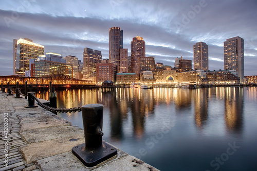 The lights of downtown reflect on the waters of the Fort Point Channel at sunset in Boston, MA. photo