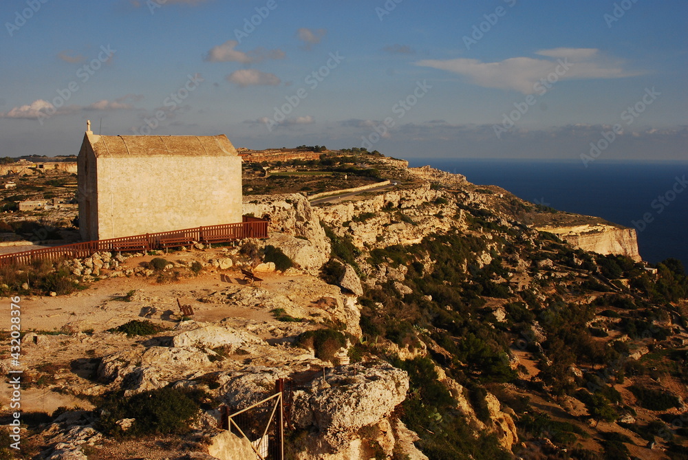 Small church in Dingli cliffs in Malta island with the stoned coast