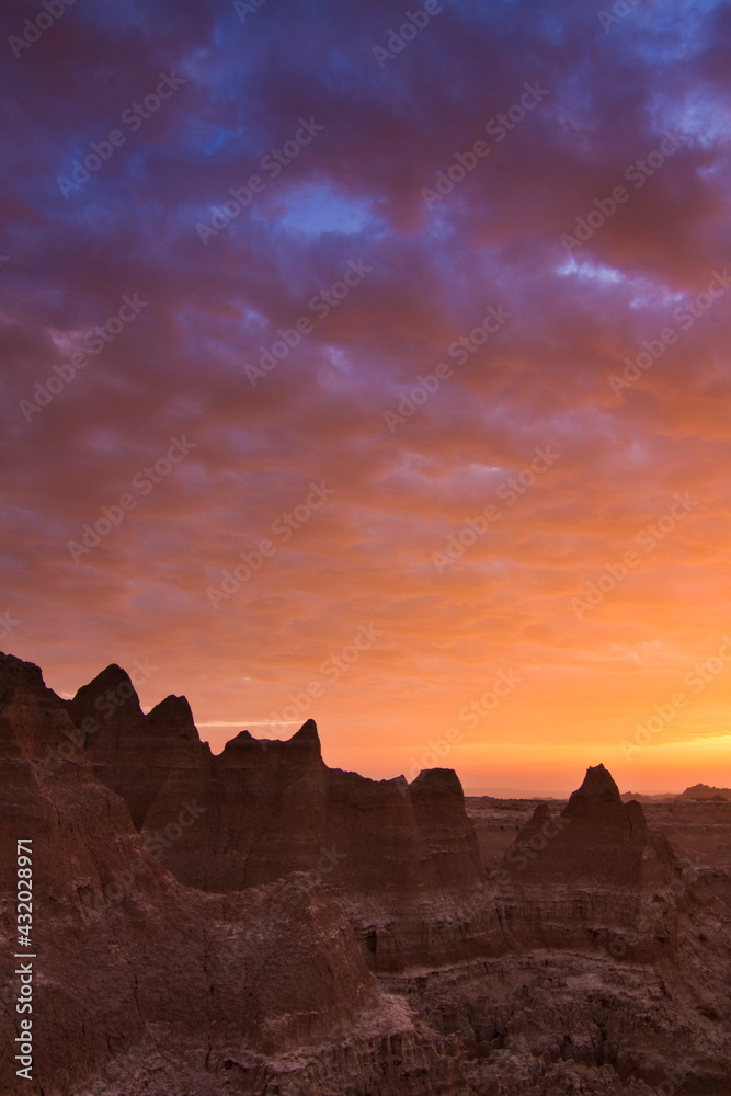 Clouds reflect color over Badlands National Park, South Dakota at sunrise. Clouds reflect color over Badlands National Park, South Dakota at sunrise.
