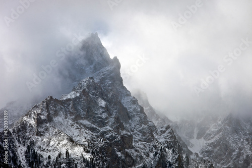 clouds and fresh snow on grand teton peaks photo