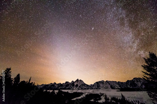 Zodiacal light shines above the Teton Mountains and the Snake River Overlook in Grand Teton National Park, Wyoming.