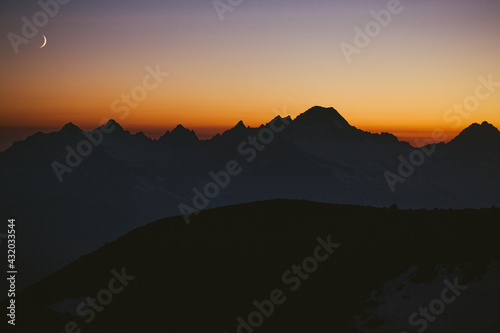 Moonrise over the cascades seen from base camp on Mt Baker, Washington. photo