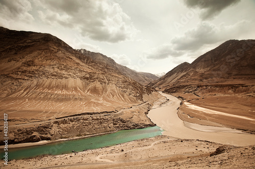 The confluence of the Indus river and the Zanskar river in the high desert of Ladakh, India photo