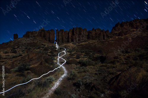 Star Trail above The Feathers in Vantage, Washington while a headlamp passes by.