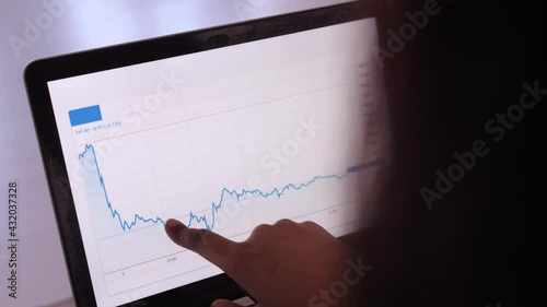 african american woman doing stock exchange chart analytics on laptop
