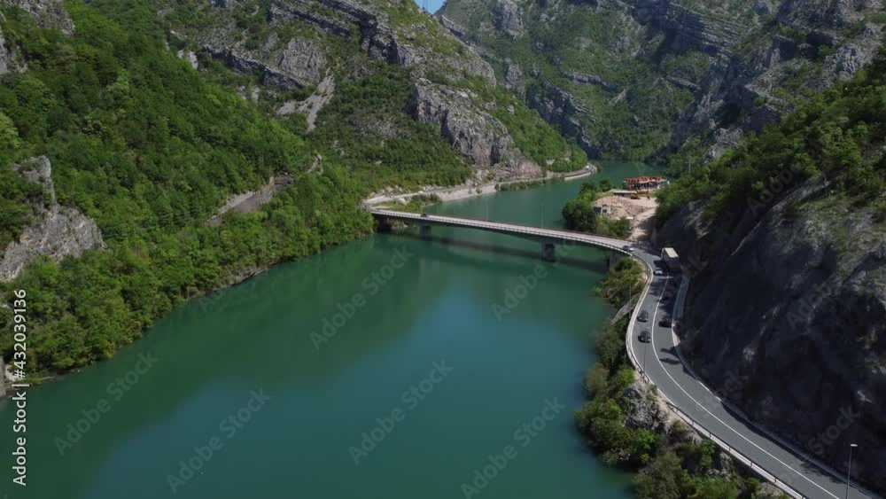Aerial drone view bridge above river in canyon. Flying above green river in early spring. Beautiful landscape in nature. Bosnia and Herzegovina. Aerial drone view bridge above river in canyon. Flying above green river in early spring. Beautiful landscape in nature. Bosnia and Herzegovina.