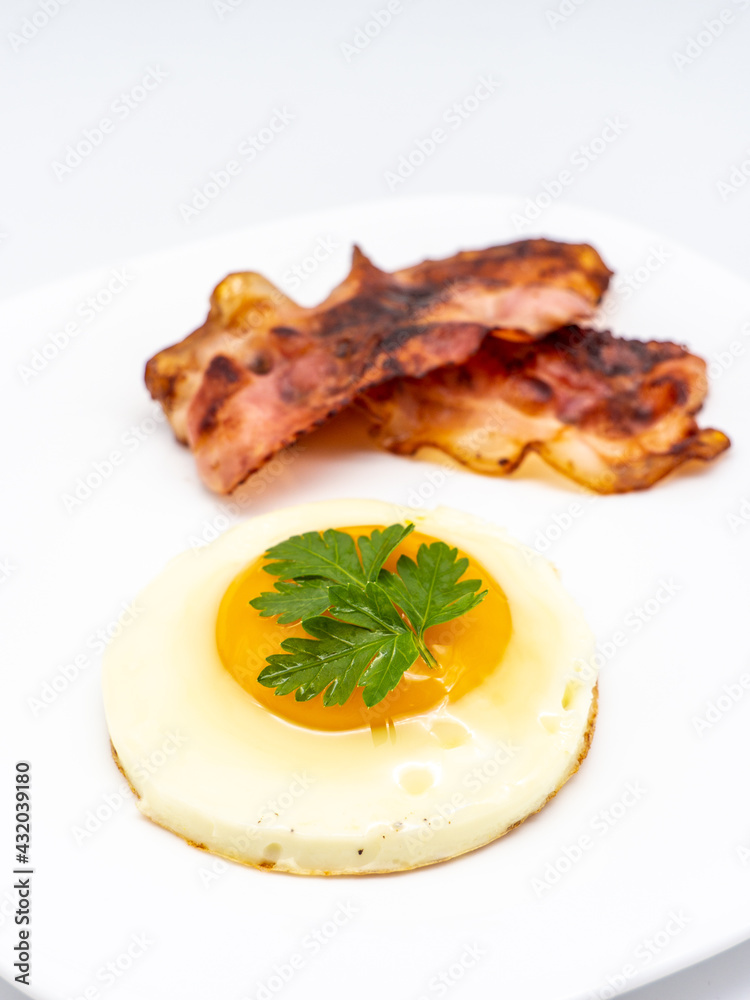fried eggs with bacon on white plate fried eggs with bacon on white plate