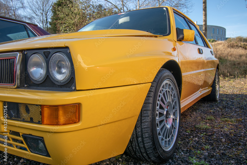 Yellow retro sport car parked on the gravel