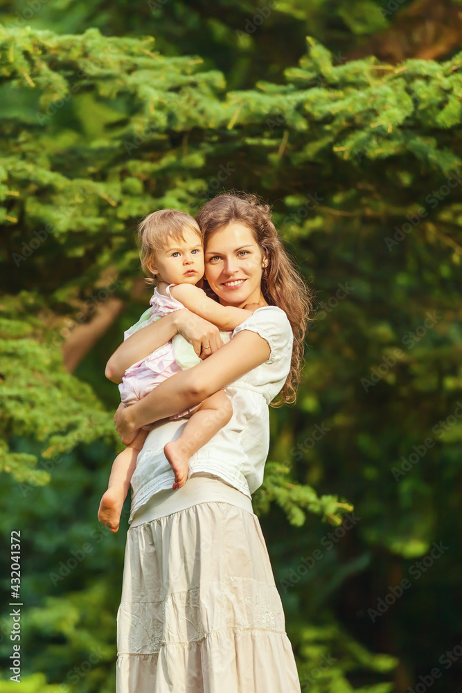Mother and little daughter playing in the park
