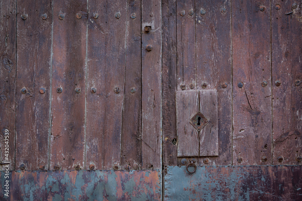 antique brown wooden door with an handle and a lock