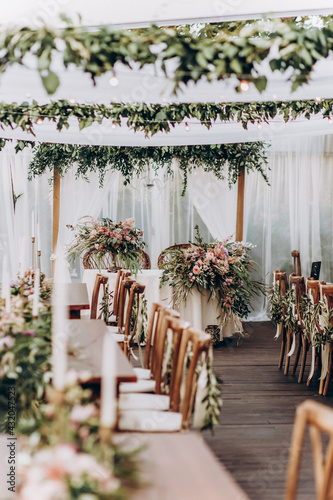 Wedding arrangement of natural flowers in boho style on wedding table.  photo