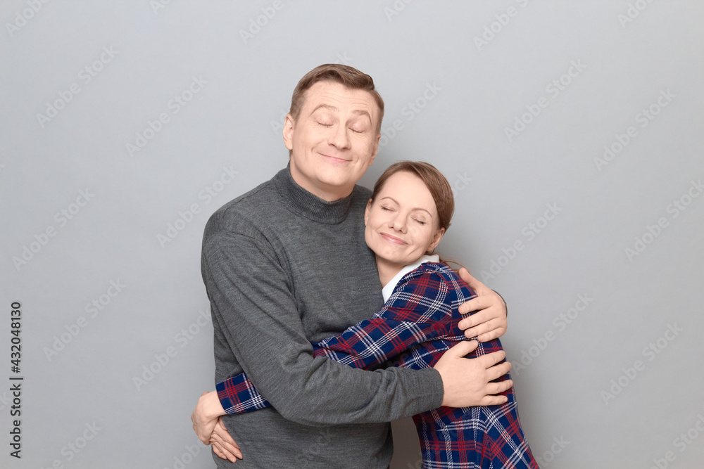 Portrait of couple hugging with pleasure and looking happy Portrait of couple hugging with pleasure and looking happy