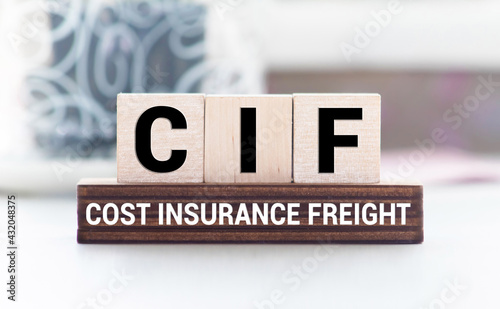 CIF words with wooden blocks on chart background. Business photo