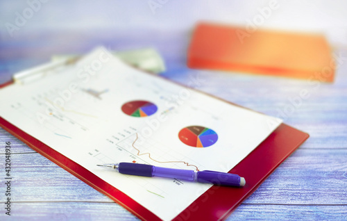 folder with graph and pen on the table