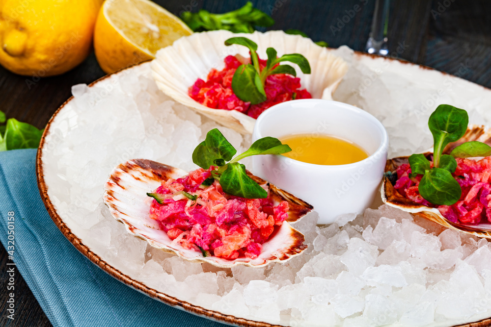 Ceviche. Finely chopped raw tuna and salmon marinated in lemon juice served in seashell.