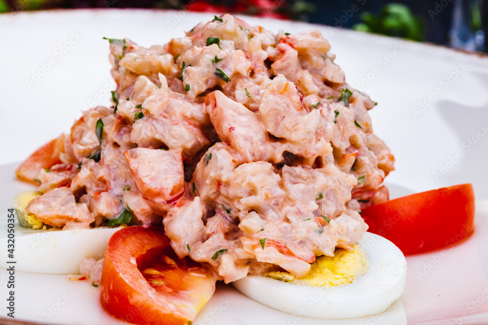 Lobster salad with egg and tomato on white plate. Lobster salad with egg and tomato on white plate.