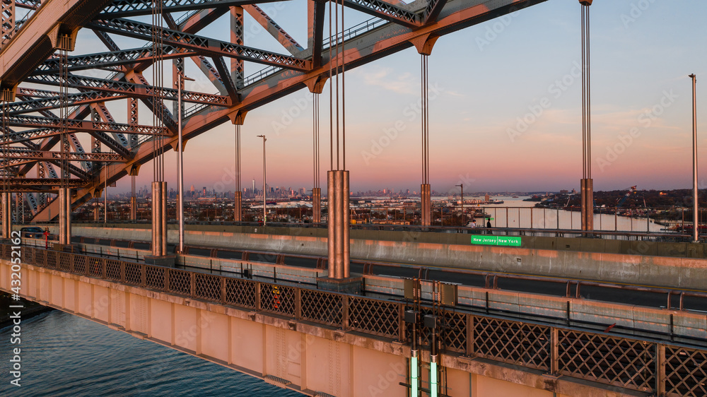 Fototapeta premium Historic Bayonne Suspended Arch Bridge over Kill Van Kull at Sunset - NJ & NY Route 440 - Bayonne, New Jersey & Staten Island, New York City, New York