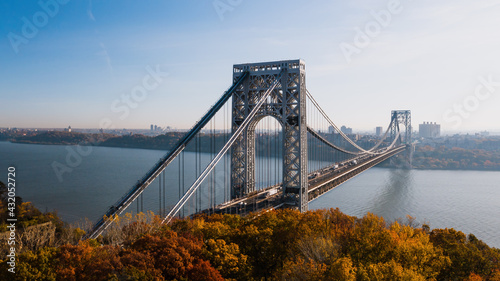 Aerial of George Washington Suspension Bridge over Hudson River at Autumn Sunrise - Interstate 95, US Route 1 & 9 - Fort Lee, New Jersey & Bronx, New York City, New York