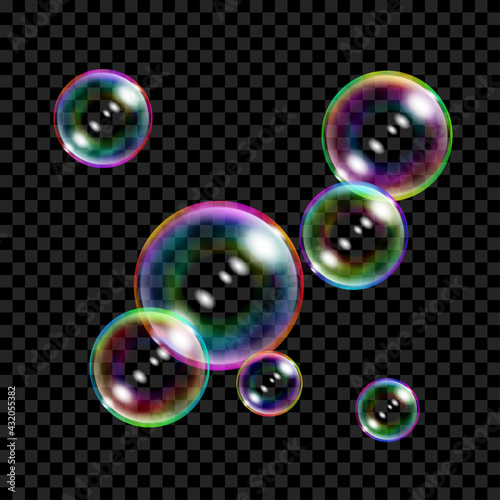 Set of several translucent colored soap bubbles on transparent background. Transparency only in vector format