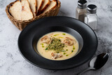 Menu photography setting for a restaurant, cheddar cheese soup, top view on a gray stone table
