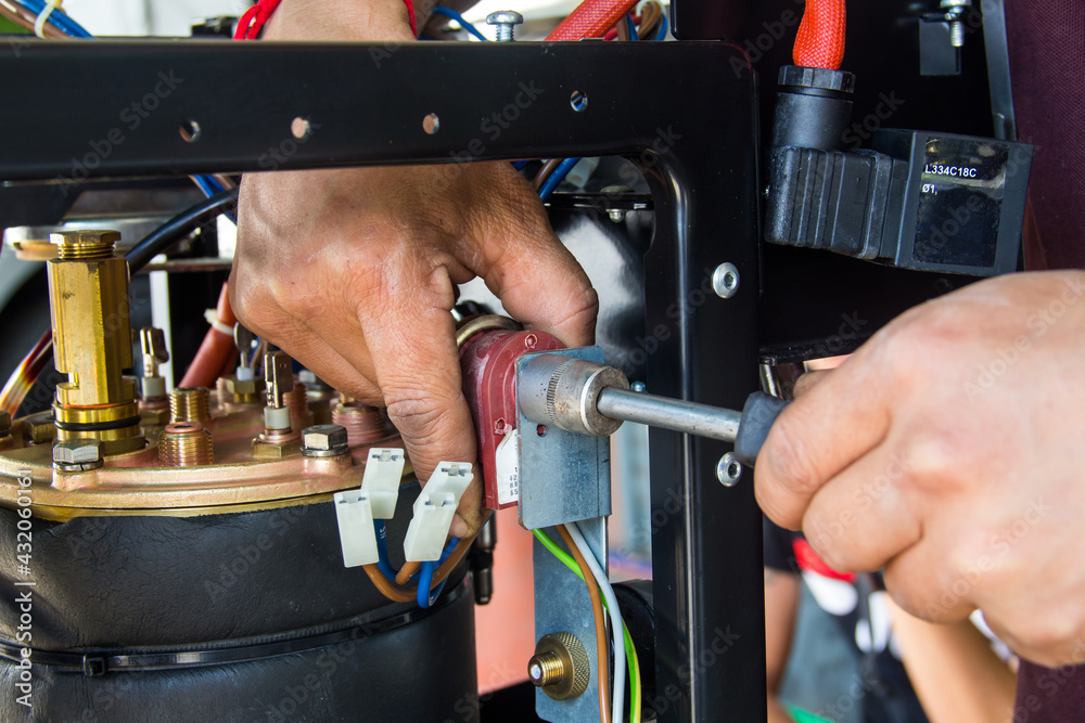 The master repairing broken coffee machine,disassembled coffee machine