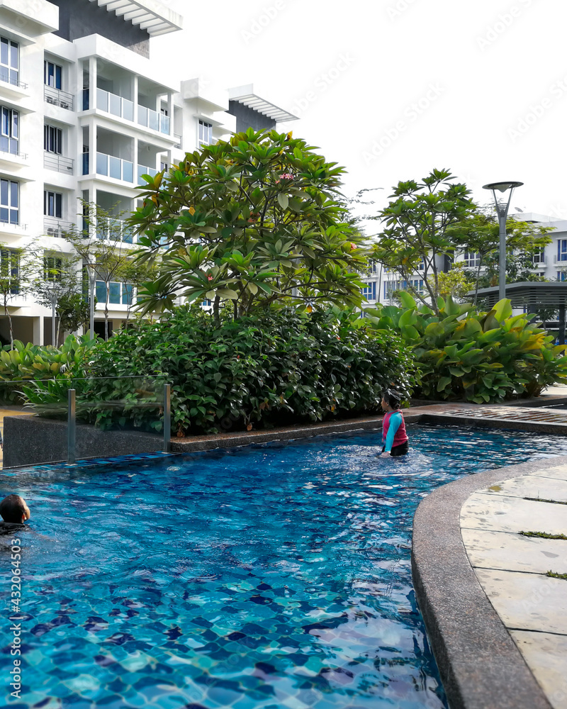 Cute Children playing in swimming pool in Apartment Putra1, Bandar Seri Putra.