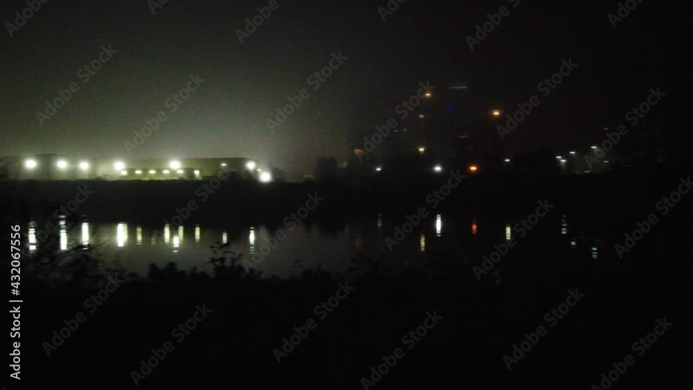Foggy Haze At Night Near Water Pond And Apartment Buildings Right To Left Pan 001 Foggy Haze At Night Near Water Pond And Apartment Buildings Right To Left Pan 001