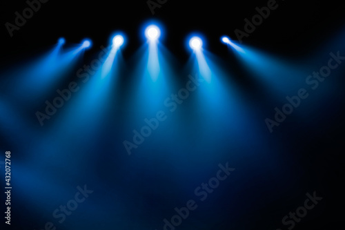 Shining spotlights and empty on stage. Dark gradient black and blue grungy background