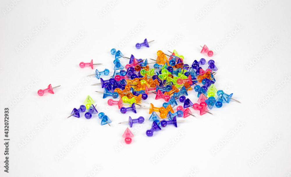 The colored pushpins on white background The colored pushpins on white background