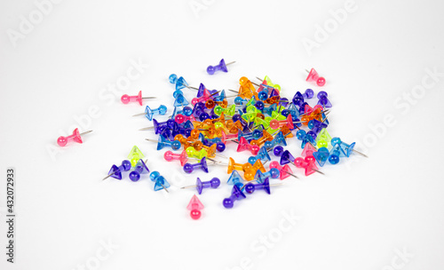 The colored pushpins on white background