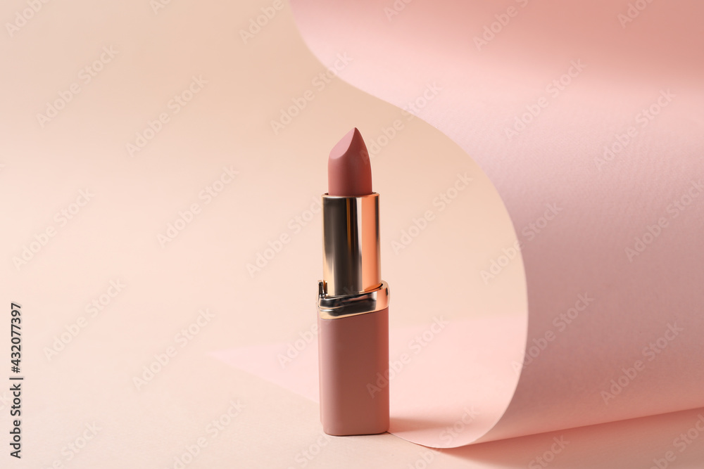 Beautiful lipstick on beige background. Professional makeup product - obrazy, fototapety, plakaty 