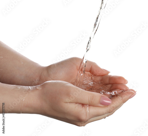 Pouring water into woman's hands on white background, closeup