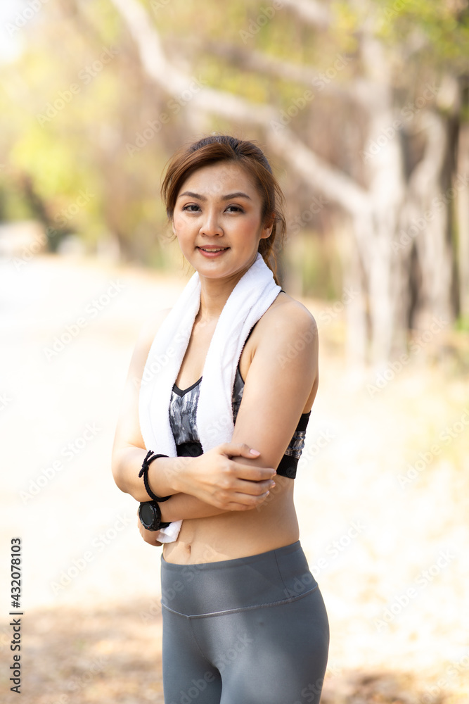 Portrait young fitness Asian woman runner running at the city park. Portrait young fitness Asian woman runner running at the city park.