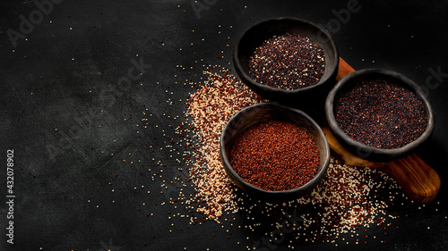 Set with different types of quinoa on dark background. Organic food concept.