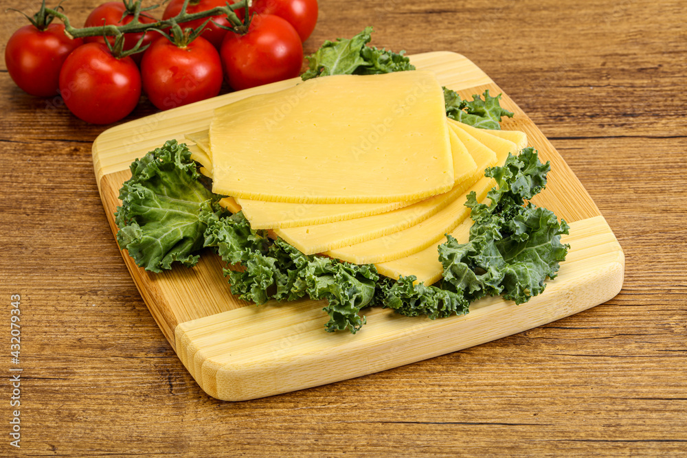 Sliced Gauda cheese over board Sliced Gauda cheese over board