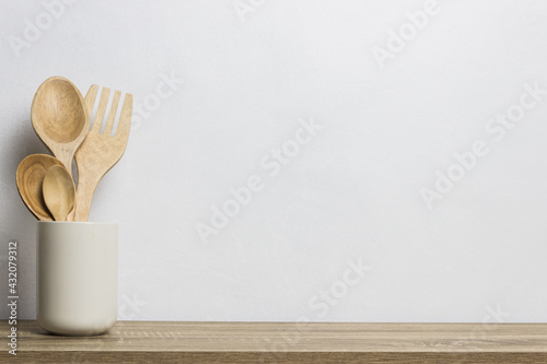 A wooden kitchen utensils on wooden table