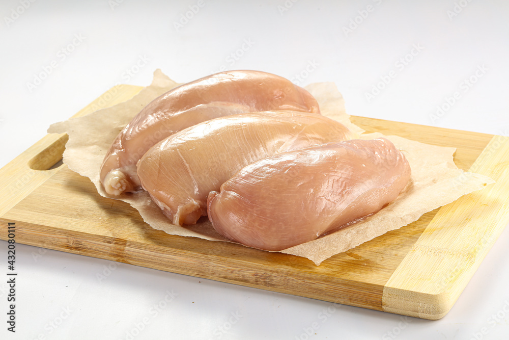Raw chicken breast fillet over board Raw chicken breast fillet over board