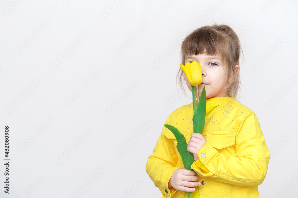 cute baby girl in yellow clothes sniffs yellow flowers cute baby girl in yellow clothes sniffs yellow flowers