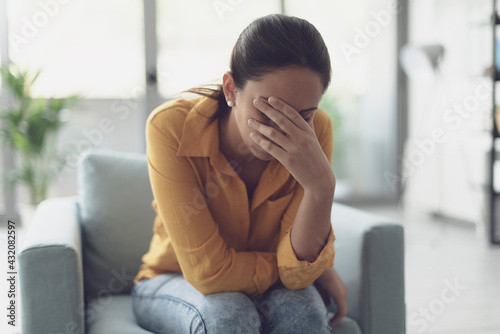 Young lonely woman crying at home