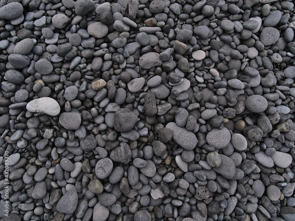 Closeup high angle view of grey colored round volcanic pebble stones at Djúpalónssandur beach on the west coast of Snæfellsnes peninsula, Iceland. Closeup high angle view of grey colored round volcanic pebble stones at Djúpalónssandur beach on the west coast of Snæfellsnes peninsula, Iceland.