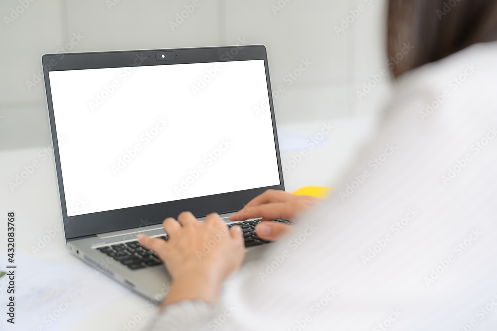 Back view of woman using notebook laptop with empty blank screen for your design or advertisement Back view of woman using notebook laptop with empty blank screen for your design or advertisement