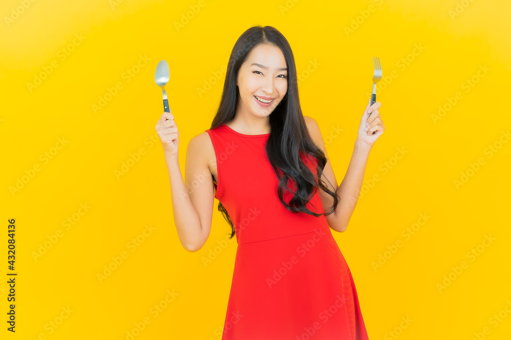 Portrait beautiful young asian woman smile with spoon and fork