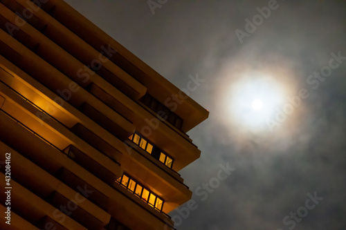 Moon next to abstract building